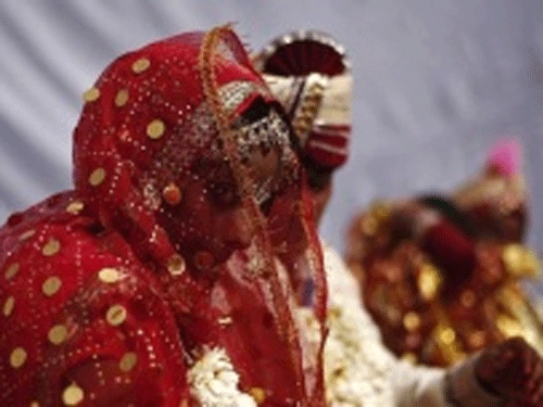A bride and groom attend a mass wedding ceremony in New Delhi . Reuters file photo