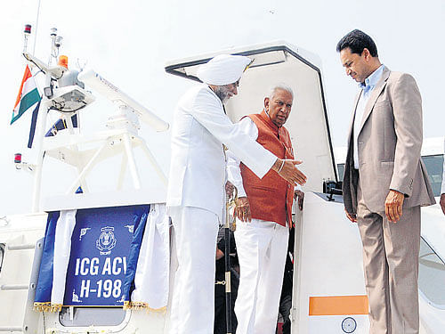 Governor Vajubhai Vala comes out of the Hovercraft H-198 after commissioning it at the Karnataka headquarters of Indian Coast Guard in Mangaluru on Monday. ICG Inspector General S P S Basra, Dakshina Kannada Deputy CommissionerAB Ibrahim and others look on. DH PHOTO