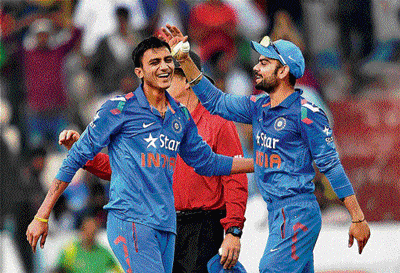COOL CUSTOMER Axar Patel (left) has shown good temperament to bowl under pressure situations. AFP photo
