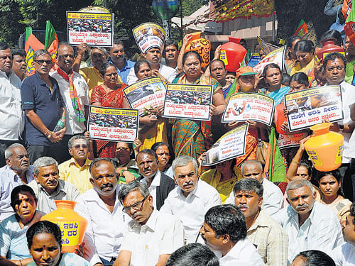 BJP members stage a protest against the water tariff hike by BWSSB, in front of Cauvery Bhavan, on Monday. dh photo
