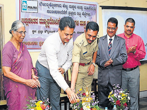 Deputy Commissioner A B Ibrahim and SP Sharanappa light the lamp to inaugurate a programme "Prajna's step towards women and child empowerment," in Mangaluru on Tuesday.