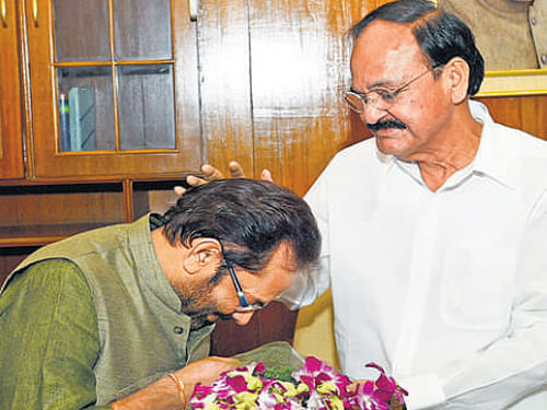 New Minister of State Mukhtar Abbas Naqvi seeks blessing from  M Venkaiah Naidu. PTI