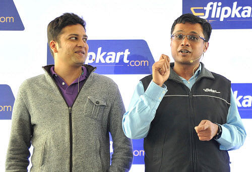 Founder of Flipkart Sachin Bansal (right) addressing a press conference as Co-founder Binny Bansal looks at him in Bangalore. File photo DH