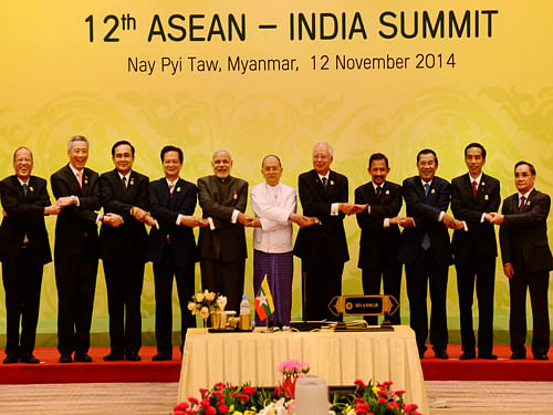 Prime Minister Narendra Modi joins hands with ASEAN leaders at a group photo session during the 12th India-ASEAN Summit in Nay Pyi Taw in Myanmar on Wednesday. PTI Photo