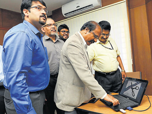 Mangalore University Vice Chancellor Prof K Byrappa launches global document verification system for verification of certificates and marks card, at Mangalore University campus on Wednesday. DH Photo