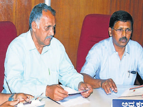 Kodagu DCC Bank President B D Manjunath speaks at a press conference in Madikeri on Wednesday. District Cooperative Union President MP Muthappa, DCC Bank general Manager Muthanna were present.DH Photo