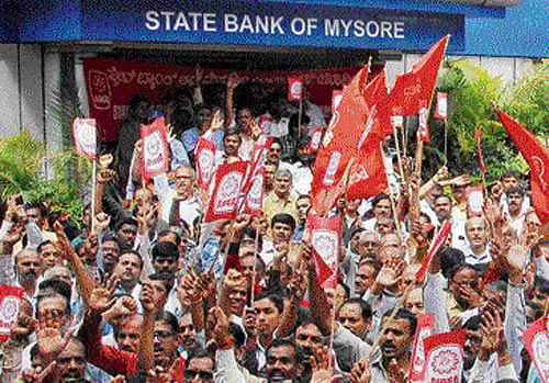 up in arms: Employees of various banks gather in front of the head office of State Bank of Mysore in Bengaluru on Wednesday, during a strike in support of their demands. dh Photo