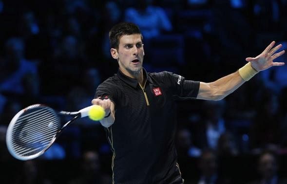 Novak Djokovic of Serbia returns the ball to Stan Wawrinka of Switzerland during their tennis match at the ATP World Tour finals at the O2 Arena in London November 12, 2014. Reuters photo