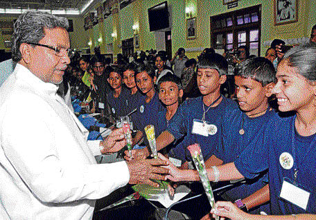 with love: Chief Minister Siddaramaiah interacts with schoolchildren on Thursday. DH&#8200;PHOTO