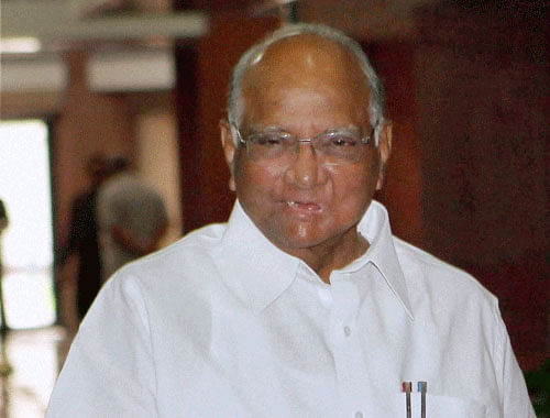 Extending his support to BJP beyond Maharashtra legislature, NCP chief Sharad Pawar today took a broom in his hands in a gesture signalling a new found bonhomie between the two parties. PTI photo