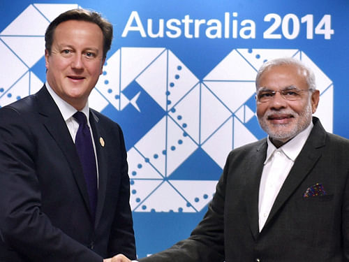 Narendra Modi held his first meeting with British Premier David Cameron who described relations with India as top priority. PTI Photo