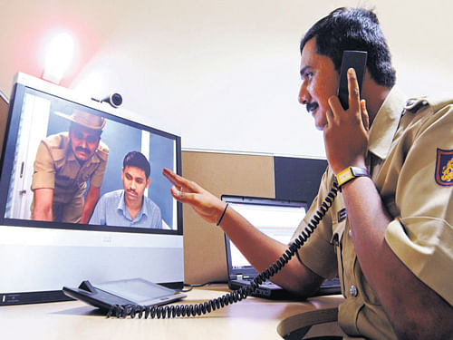 A police official monitors the remote FIR centre in Bengaluru on Friday. DH Photo/ Ranju  P