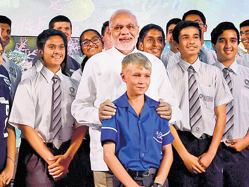 Prime Minister Narendra Modi poses for a photograph with students during a visit to Queensland University of Technology in Brisbane, Australia on Friday. PTI Photo  PTI photo
