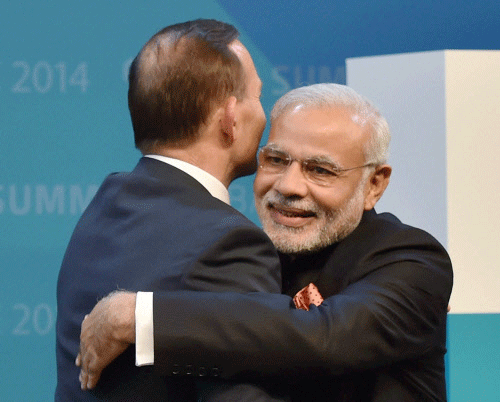 Prime Minister Narendra Modi being greeted by Prime Minister of Australia, Tony Abbott at the opening ceremony of the G20 Summit in Brisbane, Australia on Saturday. PTI Phloto