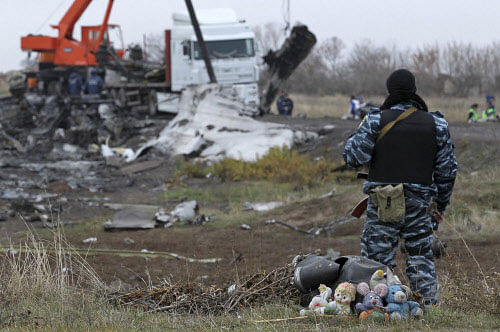 A pro-Russian armed man secures crash site wreckage of the Malaysia Airlines Boeing 777 plane (flight MH17) at the site of the plane crash near Grabovo in the Donetsk region. Reuters