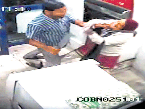A video grab of Jyothi Uday being attacked at the Corporation Bank ATM kiosk in November 2013. File photo