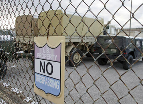 Snow-covered military vehicles parked behind Missouri National Guard depot, after a state of emergency was declared by Missouri Governor Jay Nixon, in St Louis, November 17, 2014. Reuters