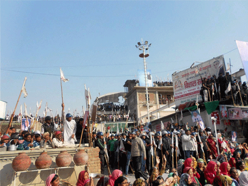 Hisar: Followers sheild the Satlok Ashram of Sant Rampal in Hisar on Monday to resist his arrest.  PTI photo