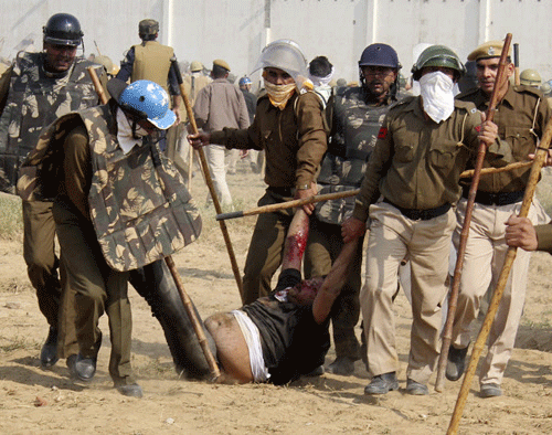 Police detain a supporter of Satguru Rampalji Maharaj, a self-styled 'godman' during a protest outside the ashram of Rampal in Hisar. Reuters photo