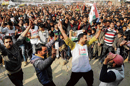 Democratic Party (Nationalist) supporters dance during a rally after party chief and Agriculture Minister Ghulam Hassan Mir filed nomination papers in Tangmarg in Baramulla district on Wednesday. PTI