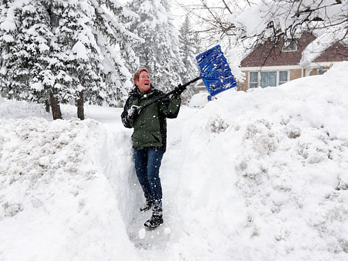 Sue Radka helps shovel out a friends driveway on Wednesday, Nov. 19, 2014, in Lancaster, N.Y. Lake-effect snow pummeled areas around Buffalo for a second straight day, leaving residents stuck in their homes as officials tried to clear massive snow mounds with another storm looming. AP Photo