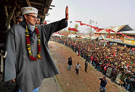 Jammu and Kashmir Chief Minister and National Conference working president Omar Abdullah waves to supporters at a rally after filing nomination papers for Assembly elections at Beerwah in Budgam district on Thursday. PTI
