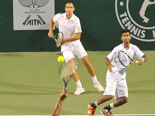Jeevan Nedunchezhiyan of Hyderabad Aces in action against Ramkumar Ramanathan and Feliciano Lopez of Bangalore Raptors in the mens doubles in the Champions Tennis League at KSLTA courts in Bengaluru. DH photo