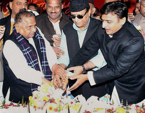 Samajwadi Party supremo Mulayam Singh Yadav with Uttar Pradesh Chief Minister Akhilesh Yadav and Azam Khan cutting cake on the occassion of Mulayam Singh Yadav's 76th birthday. PTI Photo