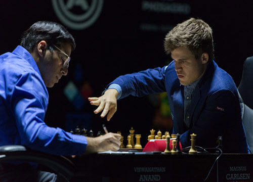 Norway's Magnus Carlsen, right, currently the top ranked chess player in the world, plays his 11th game against India's former World Champion Vishwanathan Anand, at the FIDE World Chess Championship Match in Sochi, Russia, Sunday, Nov. 23, 2014 . AP Photo