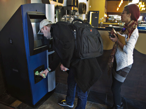 A customer puts money into the world's first ever permanent bitcoin ATM unveiled at a coffee shop in Vancouver. Bitcoin does not protect a user's IP address and the digital currency can be linked to the user's transactions in real-time by hackers, scientists have warned. Reuters file photo