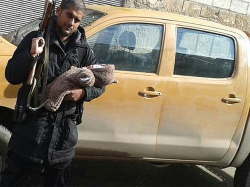 A 31-year-old Indian-origin Islamic State suspect, who is fighting in Syria, has posted a picture of him on Twitter posing with an AK-47 rifle and his new born baby. Photo Courtesy : Twitter