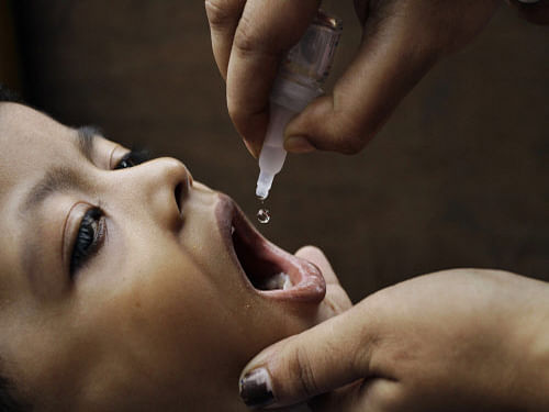 A child is administered the polio vaccine. The WHO today suspended its activities in Pakistan's restive Balochistan province due to security concerns after four members of a polio vaccination team were gunned down by militants, in one of the deadliest attacks on medical workers in the region. AP file photo