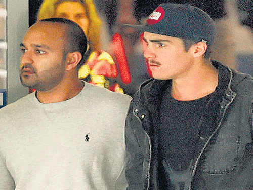 Bowler Sean Abbott (right) leaves the St Vincent Hospital after paying his tributes to Phil Hughes.
