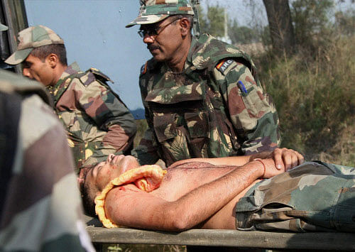 An injured army Jawan is taken to hospital during an encounter with militants at Pindi village of Arnia sector about 45km from Jammu on Thursday. PTI Photo