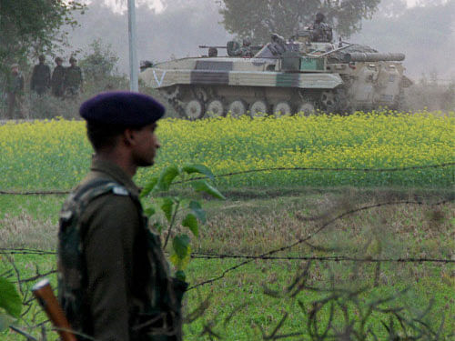 An army jawan during an encounter with militants at Pindi village of Arnia sector about 45km from Jammu. The toll in the gunfight between the security forces and infiltrators that restarted Friday after a lull has risen to 11. Heavy firing is on in Jammu district ahead of the prime minister's election rallies in the state. PTI photo