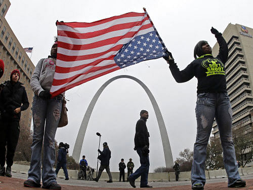 Protesters stand in front of the Gateway Arch as they demonstrate in downtown St. Louis. Amid an uneasy calm in Ferguson and subdued protests across the US during the Thanksgiving holiday, a plot to blow up St. Louis' Gateway Arch and assassinate the county prosecutor, came to light. Reuters photo