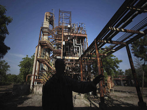 A security guard is silhouetted against defunct machinery at the Union Carbide pesticide plant. The toxic waste after the Bhopal Gas tragedy lying at the Union Carbide plant here is still awaiting disposal, even after 29 years of the world's worst industrial disaster, amid concerns of air and water pollution. AP photo