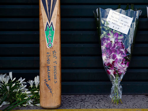 Messages and flowers of tribute to Australian cricketer Phillip Hughes can be seen outside the main gates to the Sydney Cricket Ground. Reuters photo