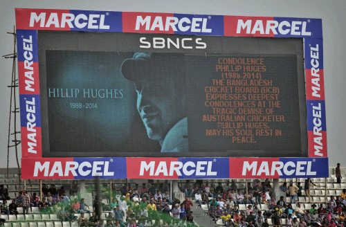 A screen shows a portrait of Australia's cricket player Phillip Hughes before the fourth one-day international cricket match between Bangladesh and Zimbabwe, in Dhaka, Bangladesh, Friday, Nov. 28, 2014. Hughes, the 25-year-old cricketer who played 26 tests for Australia died at St. Vincent's Hospital on Thursday, two days after he was struck on the head by a short-pitch ball during a match. AP photo