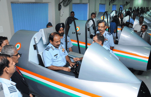 Chief of Air Staff- Air Marshal Arup Raha sits in a cock-pit installed at Psychomotor Skills Division during the inauguration of Computerised Pilot Servises System at Air Force Selection Board in Mysuru on Friday. DH photo