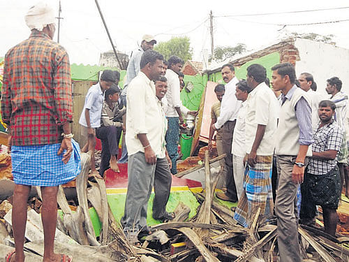 Officials inspect the house of a midday mealworker where a pressure cooker exploded injuring seven, in Tenkalahundi village of Gundlupet taluk on Saturday. DH PHOTO