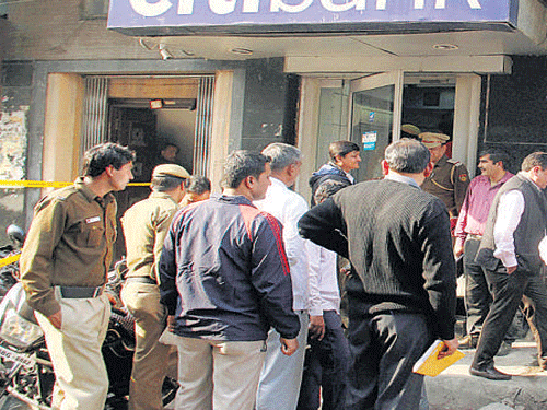 Police officials investigate near a Citibank kiosk . PTI