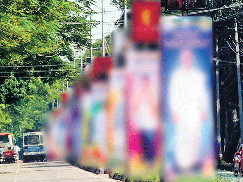 Flexes and hoardings dot City roads, taking over footpaths, road dividers, trees and electricity poles. DH file photo