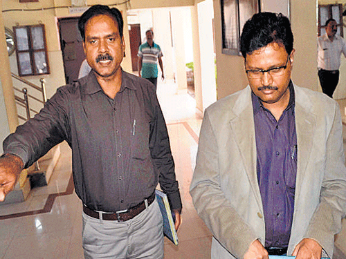 Senior IPS officer Rajesh Kumar(right)comes out of the CBI office in Bhubaneswar on Sunday after his interrogation. DH Photo