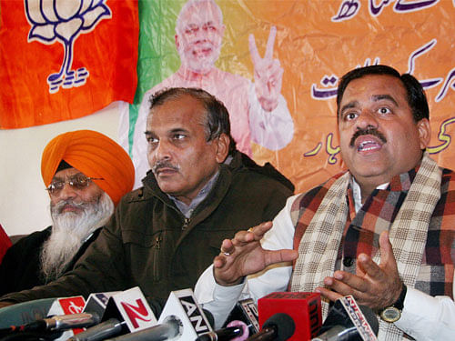 Bhartiya Janata Party (BJP) All India Secretary Tarun Chung (R) along with Party State Vice-President Ramesh Arora (C) addressing a press conference at the releases the party manifesto for assembly elections, in Srinagar on Monday. PTI Photo