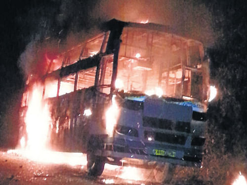 An accidental fire engulfed a bus, at Sannampady near Uppinangady in the wee hours on Monday. (Below) The police look at the ramains of the bus. DH photo