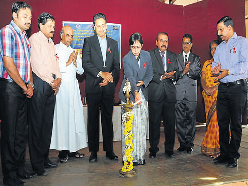 Principal District and Sessions Judge Uma M G lights a lamp to inaugurate World Aids Day programme at St Aloysius College in&#8200;Mangalore on Monday. Deputy Commissioner A&#8200;B&#8200;Ibrahim, Bar Association President S&#8200;P&#8200;Chengappa, Senior Civil Judge Ganesh B, District AIDS Prevention and Control Unit Officer Dr Kishore Kumar and St Aloysius College Principal Fr Swebert D'Silva among others look on. DH&#8200;photo