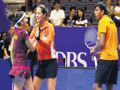 joyous camp Indian Aces' Ana Ivanovic (centre) rushes to congratulate Sania Mirza (left) and Rohan Bopanna after the pair won their match against UAE Royals. Reuters photo