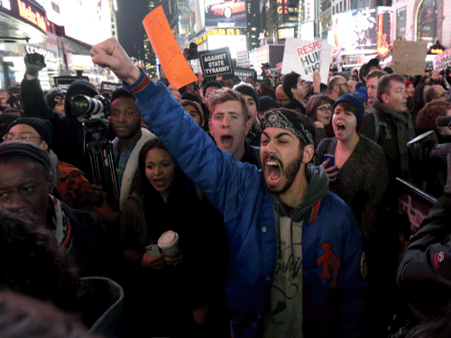 Protestors shout at Times Square after it was announced that the New York City police officer involved in the death of Eric Garner is not being indicted. A grand jury cleared the white police officer Wednesday, although the city medical examiner ruled Garner's death a homicide and found that a chokehold contributed to it. AP photo