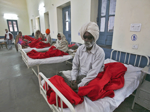 People sit on beds while waiting for treatment at a hospital after undergoing cataract removals from a free eye surgery camp, in Amritsar. Reuters photo